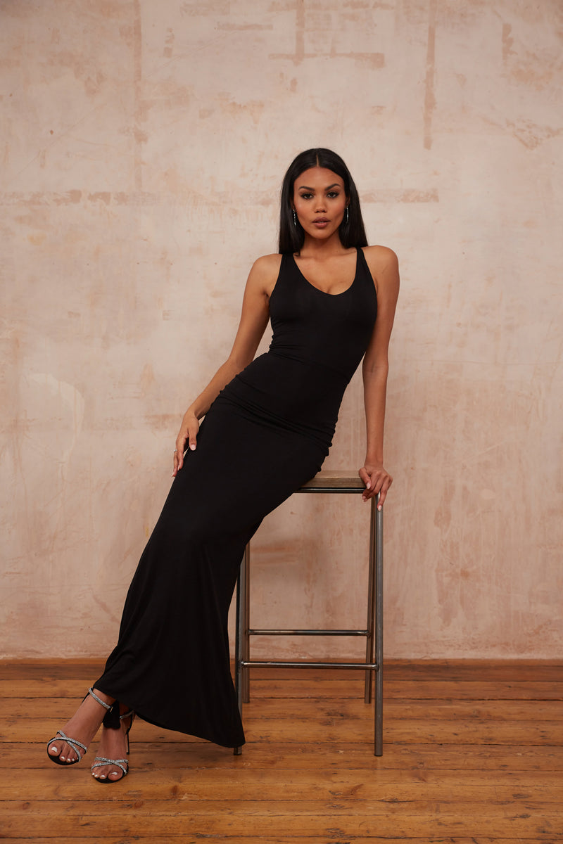 Model in black bamboo double layer maxi dress with a v neck front very flattering